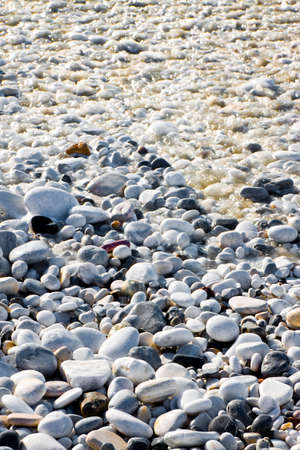 Rounded and smooth pebbles wet by seawaterの写真素材