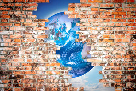 Through a cracked wall you can see the world - freedom concept imageの写真素材