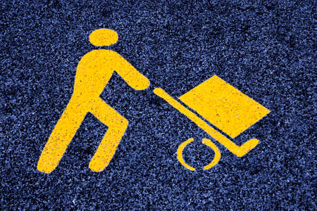 Loading goods urban symbol on asphalt road - toned image