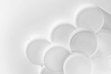 White plastics caps on white background - Image with copy space