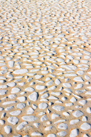 Detail of a pebble floor with white polished stoneの写真素材