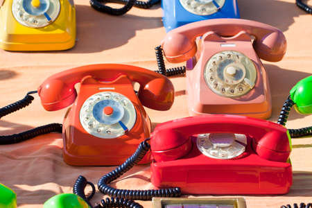 Old colored plastic analog phone in a flea market