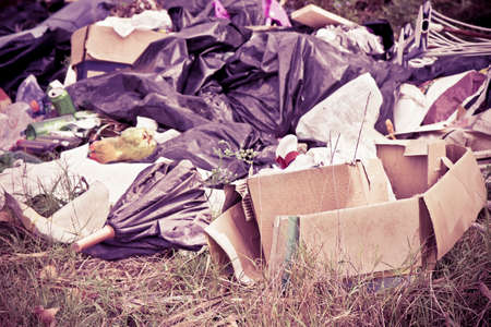 Illegal dumping with bottles, boxes and plastic bags abandoned in natureの写真素材