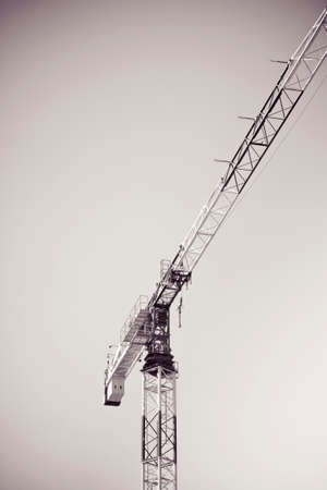 Tower crane isolated in sepia backgroundの写真素材