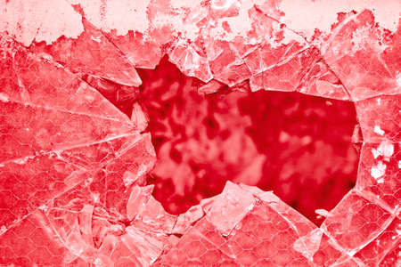 Old damaged glass reinforced with wire mesh - toned imageの写真素材