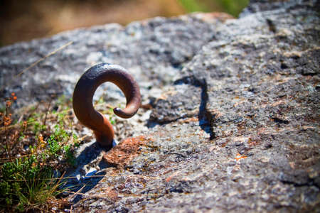 Rusted hook in a stone - concept imageの写真素材