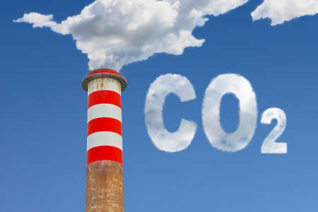 High concrete chimney emits CO2 into the atmosphere - concept image