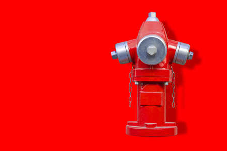 Red hydrant on red background - image with copy spaceの写真素材