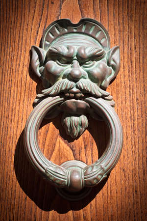 Door knoker on an old wodden door (Tuscany - Italy)