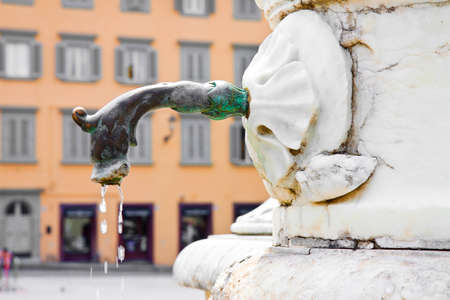 Italian ancient brass fountain with dragon head with copy spaceの写真素材