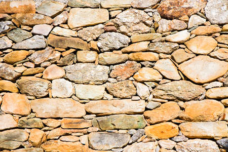 Embankment wall built with blocks of stone.The blocks of stone are only superimposed on each other;...