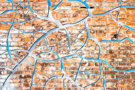 Abstract graphic image with cloudy sky behind a cracked brick wall
