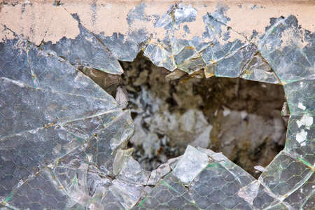 Old damaged glass reinforced with wire mesh の写真素材