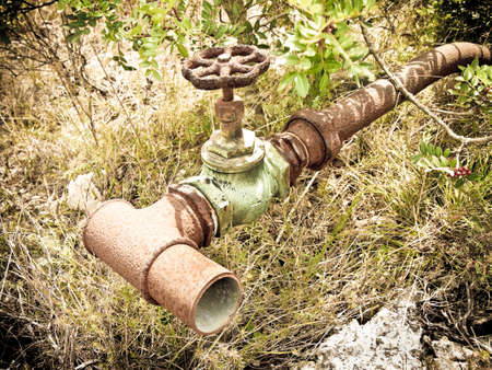 Detail of an old rusty hydraulic valve - toned  image - vignette added