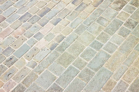 Typical old Tuscany paving made with carved stone blocks (Italy)