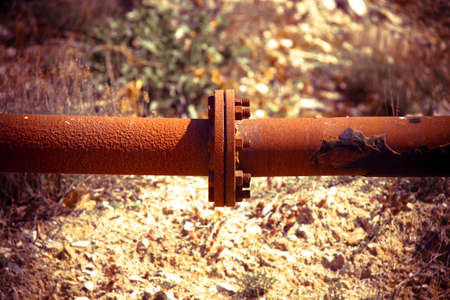 Detail of a rusty pipeline - concept image with vignette added