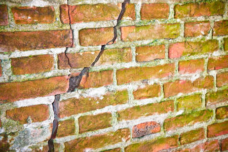 Deep crack in old italian brick wall - concept image