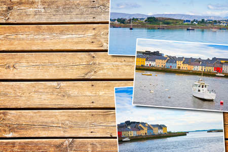 Irish coastal landscape with the typical colored fishermen's houses - postards concept on colored wooden backgroundの写真素材