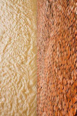 Brick wall for containing a water channel - concept image