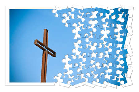 Rusty iron cross against a blue background - Rebuild our faith - Christian cross concept image in...