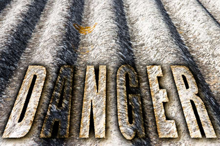 The word "danger" written with letters having asbestos graphics backgroundの写真素材