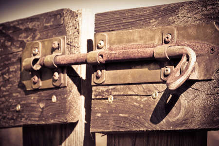 Closed wooden gate with bolt - concept image - toned imageの写真素材