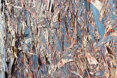 Detail of a weathered OSB (Oriented Strand Board) wooden panel