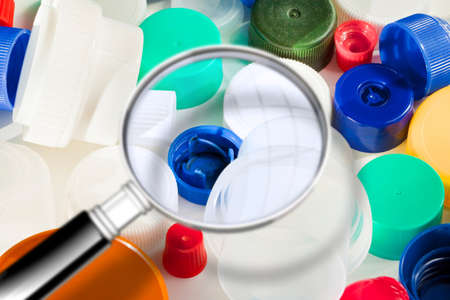 Group of colorful plastic caps - Concept image seen through a magnifying glassの写真素材