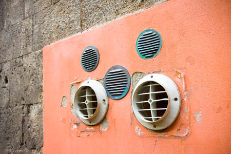 Venting on colored plaster wall with copy spaceの写真素材