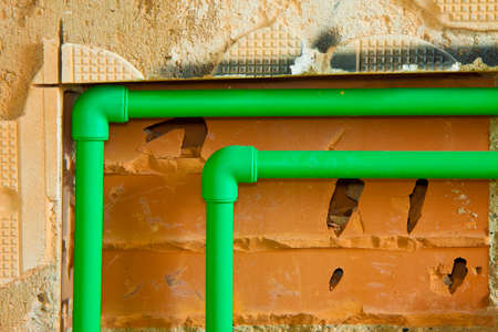 Detail of a new hydraulic system with a green polypropylene pipes for hot and cold water in an...