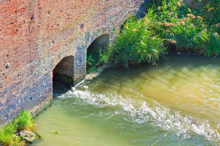 Dangerous toxic polluted water running towards the river.