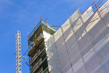 Scaffolding to work on the facade on blue backgroundの写真素材