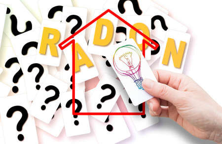 Doubts, Questions, Uncertainties and Solutions about Radon Gas in buildings - concept image with hand holding a card with light bulb.の写真素材