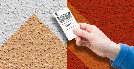 Female hand holds a parking ticket - parking payment concept on colored background - image with copy...