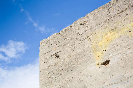 Old reinforced concrete structure with damaged and rusty metallic reinforcement bars - image with copy space.の写真素材