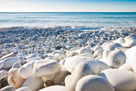 Beach with white and gray stones softly roundedの写真素材