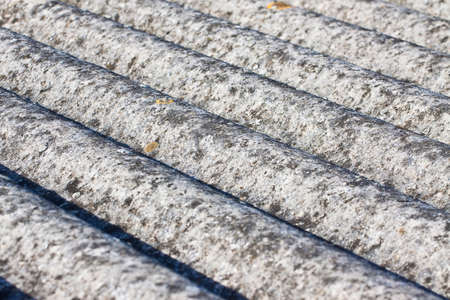 Detail of an old aged dangerous roof made of corrugated asbestos panels - one of the most dangerous materials in buildings and construction industry called hidden killer.の写真素材