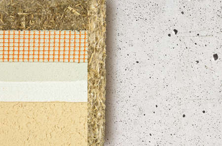 Thermal insulation coatings with hemp for building energy efficiency and reduce thermal losses against an old concrete wall - Building energy efficiency and savings concept image with copy space.の写真素材