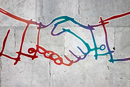 Handshake drawn on a stone wall - concept imageの写真素材