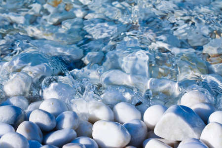White and gray stones softly rounded and washed from fresh sea water.の写真素材