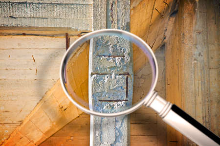 Old danger reinforced concrete pillar structure with damaged and rusty metallic reinforcement that...