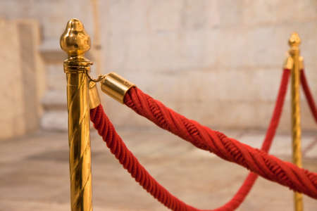 Metal railing stand with red rope for museum or exhibition.の写真素材