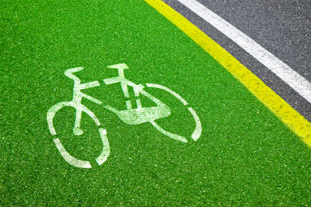 Bicycle Lane - bicycle silhouette drawn on green asphalt.の写真素材