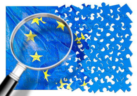 Researching the problems of contemporary Europe - concept image with a frayed European flag in jigsaw puzzle shape seen through a magnifying glassの写真素材