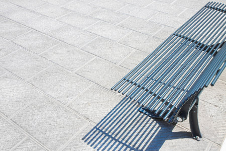 New paving made with stone blocks in an italian pedestrian zone with flowerbed and modern steel...