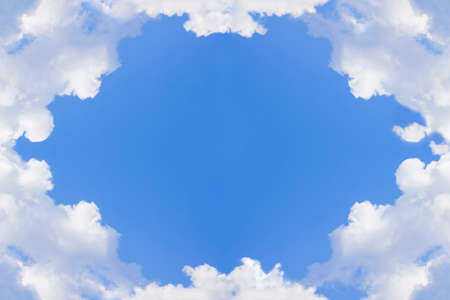 Blue sky background with white clouds - image with central space for textの写真素材