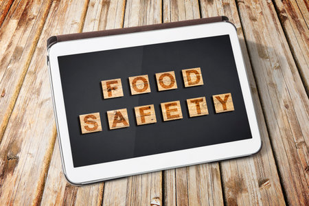 Food Safety and Quality Control in food industry - concept text against a dark background - concept on digital tabletの写真素材