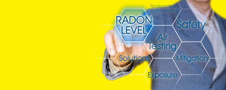 The danger of radon gas - concept with business manager pointing to icons against a digital display - image with copy space for text insertionの写真素材