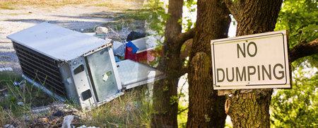 No Dumping road sign indicating in the countryside with sign hanging on the tree trunkの写真素材