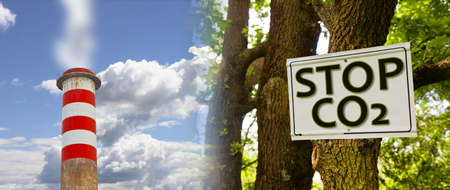 Stop CO2 emissions written on road sign in the countryside against a tree with concrete chimney emits CO2 into the atmosphereの写真素材